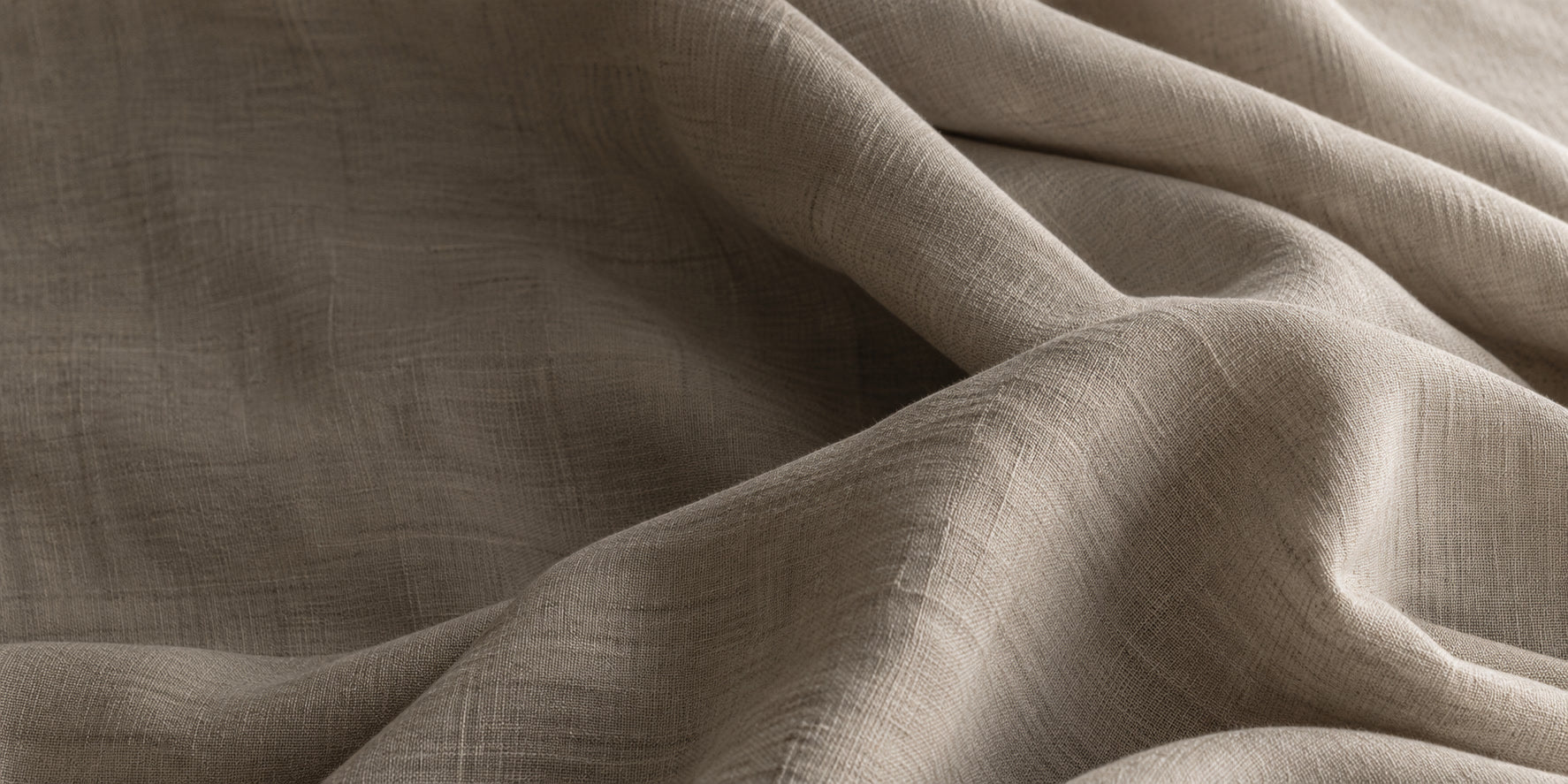 Soft oatmeal fabric folds in natural light